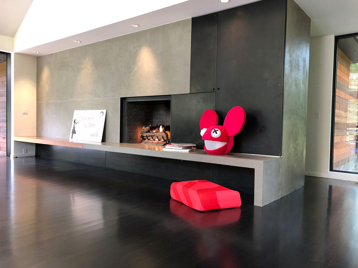 red dog bed in modern home with Dedmau5 mask and hanksy art