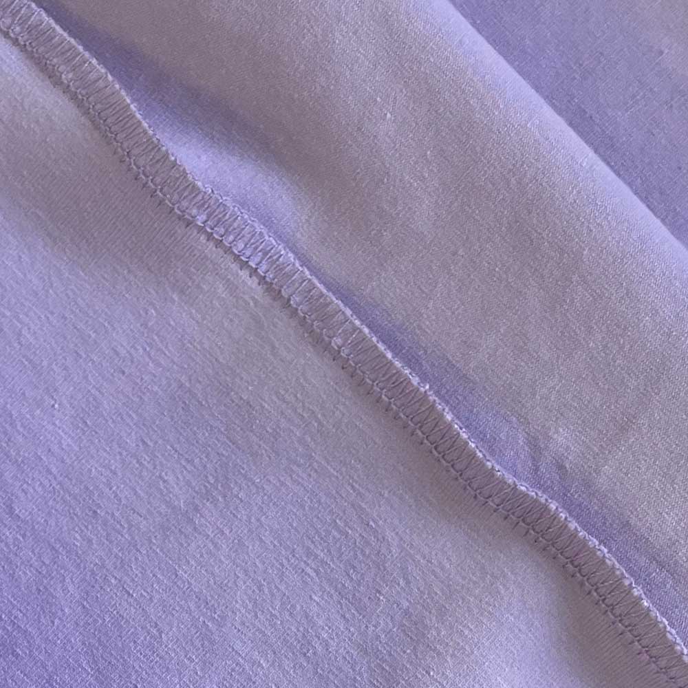 Closeup detail of purple machine washable, anti odor, anti-microbial, fitted dog bed cover.
