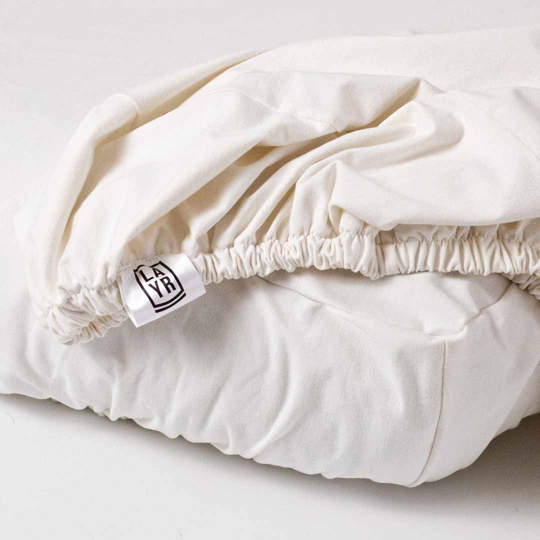 Sustainable dog bed and machine washable, fitted white dog bed cover.