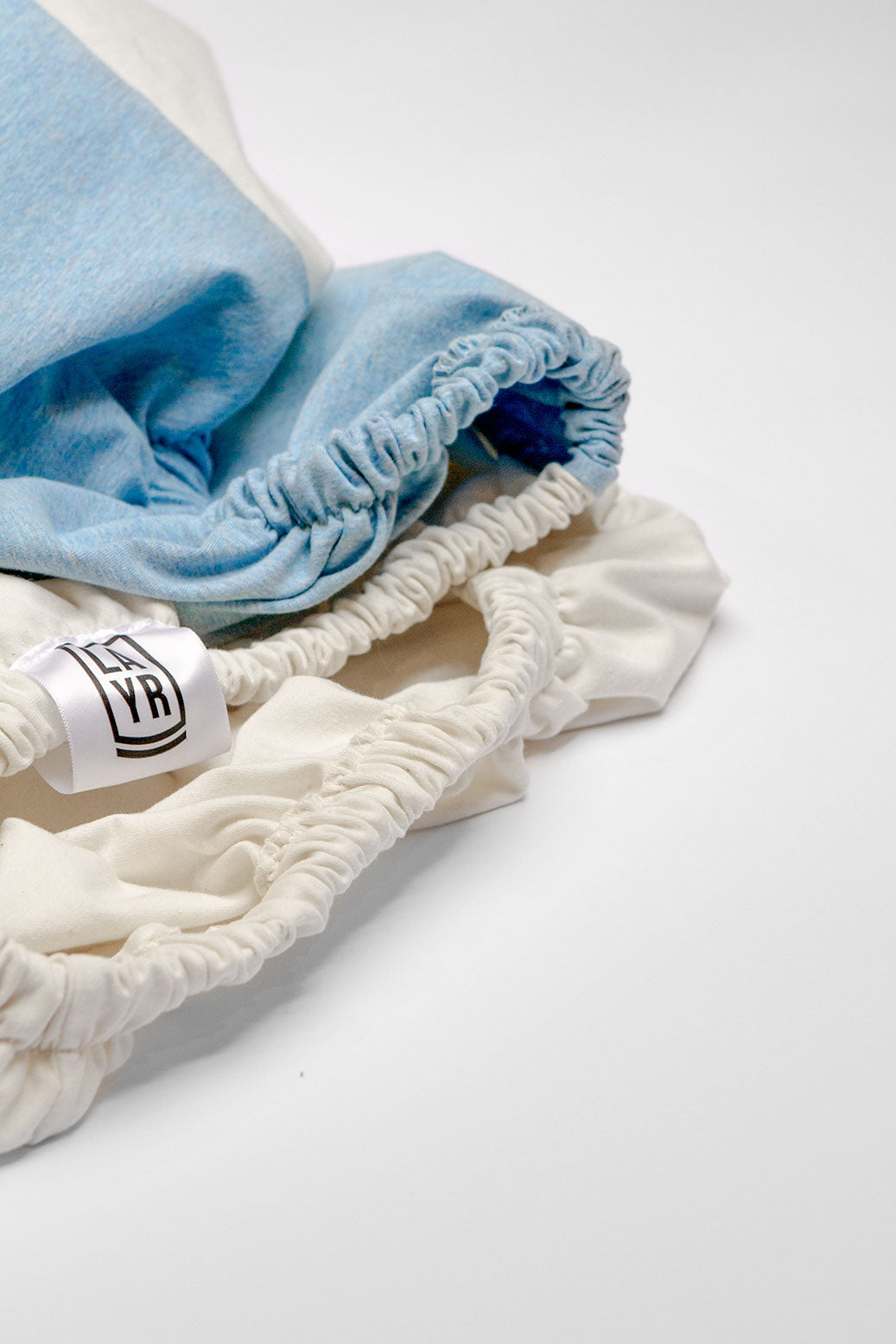 White and blue machine washable, fitted dog bed cover.