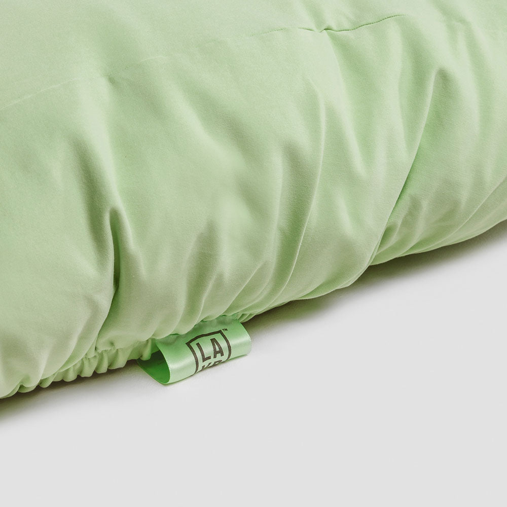 Closeup detail of green LAYR dog bed sheet tag.
