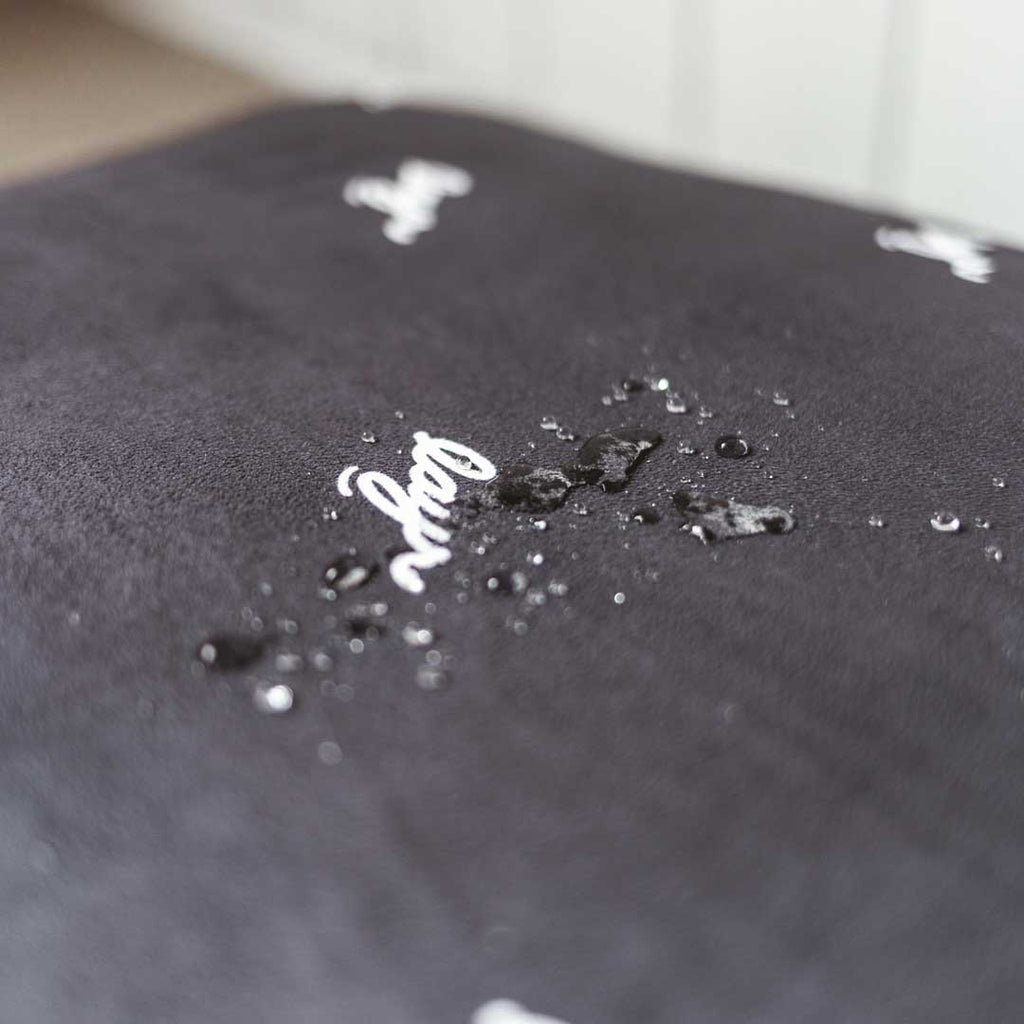Water droplets on waterproof microsuede black dog bed. 
